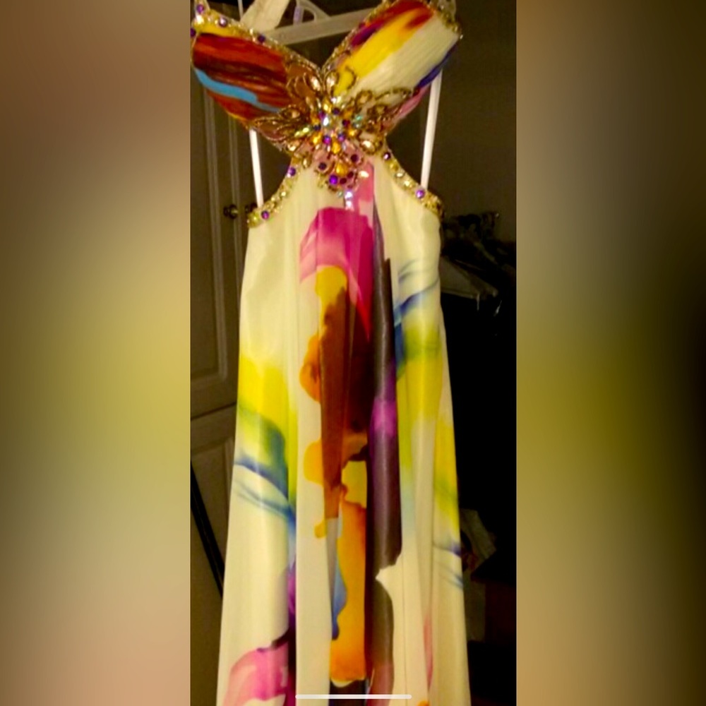 This is a one of a kind couture dress with teal crystal and rhinestones.
